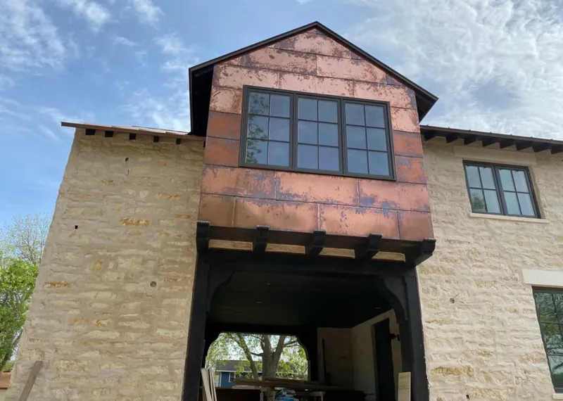 Copper metal panel facade on a stone building for Metal Roof Coating in Woodfin