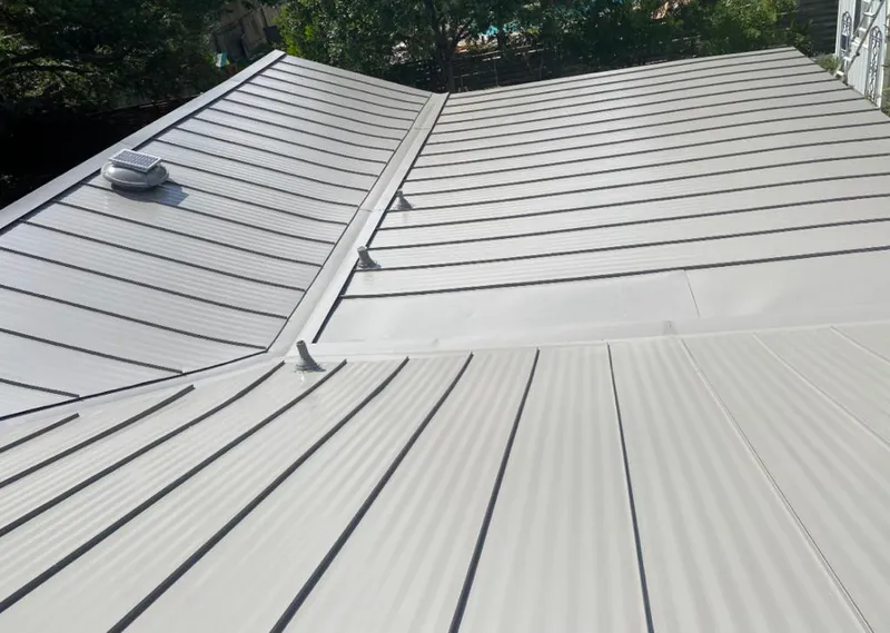 Solar attic fan installed on a metal roof for Roof Ventilation in Woodfin